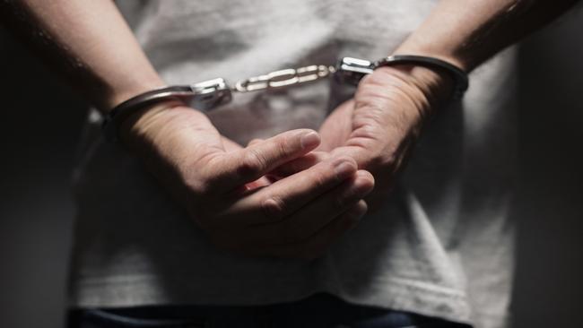 Generic stock image of a man in handcuffs.