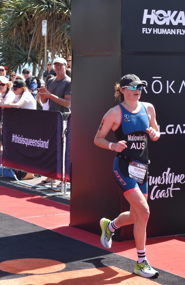 Athletes crossing the finish line at the Sunshine Coast Ironman 70.3 2023.