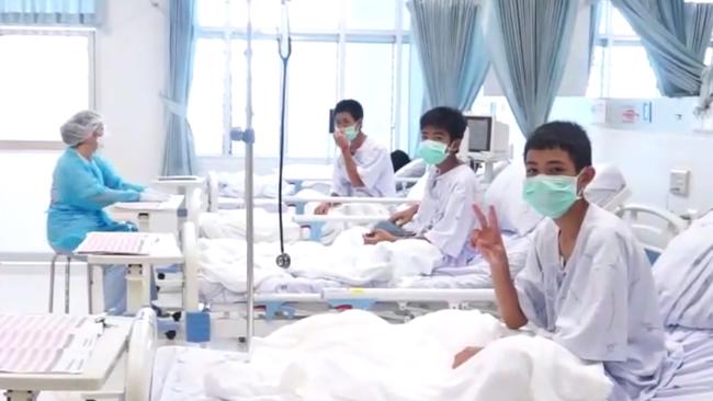 The boys sit up in bed giving the V for Victory sign. Picture: AFP/.