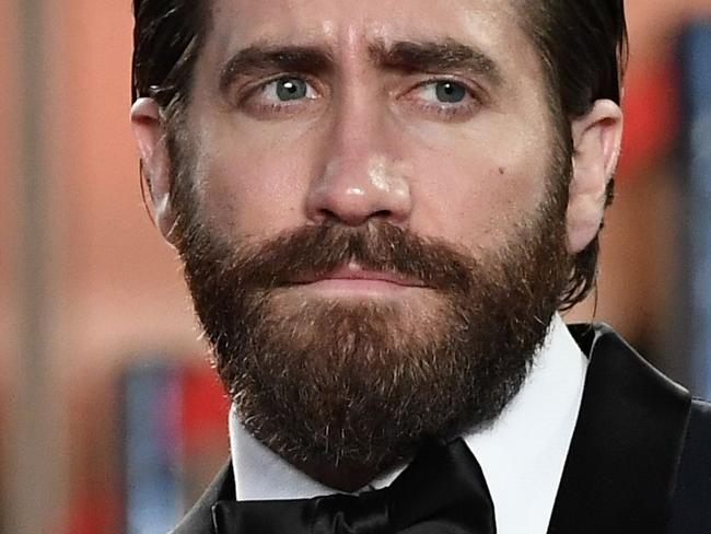 US actor Jake Gyllenhaal leaves on May 19, 2017 following the screening of the film 'Okja' at the 70th edition of the Cannes Film Festival in Cannes, southern France.  / AFP PHOTO / Anne-Christine POUJOULAT