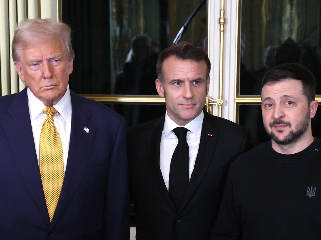 French President Emmanuel Macron stood between Ukrainian President Vladimir Zelenskyy and then-President-Elect Donald Trump in Paris on December 7, 2024. Trump called Zelenskyy a “dictator” this week. Picture: Oleg Nikishin/Getty Images