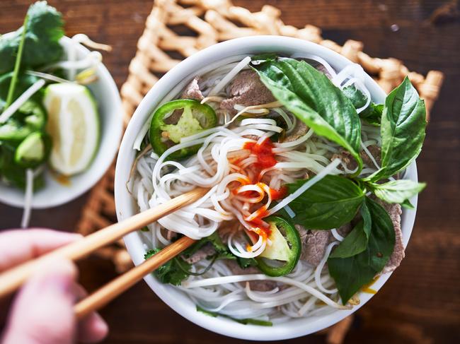 vietnamese pho with spicy sriracha sauce shot top down