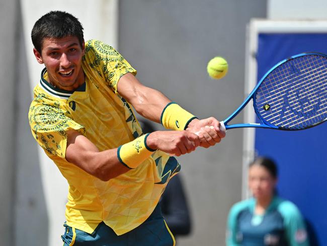 Australia's Alexei Popyrin returns to Switzerland's Stan Wawrinka during their men's singles second round tennis match at the Roland-Garros Stadium at the Paris 2024 Olympic Games, in Paris on July 30, 2024. (Photo by Miguel MEDINA / AFP)