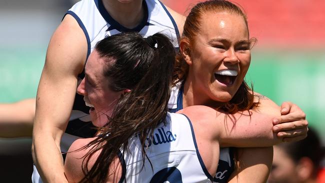 GOLD COAST, AUSTRALIA - SEPTEMBER 21: Kate Kenny of the Cats celebrates kicking a goal with team mates during the round four AFLW match between Gold Coast Suns and Geelong Cats at People First Stadium, on September 21, 2024, in Gold Coast, Australia. (Photo by Matt Roberts/Getty Images)