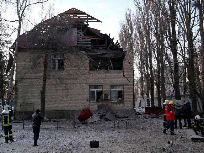 Rescuers and police experts examine remains of a drone following a strike on an administrative building in the Ukrainian capital Kyiv. Picture: AFP