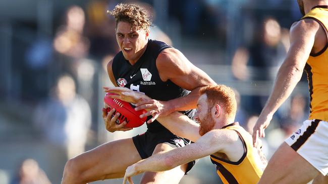 Charlie Curnow evades the clutches of Hawthorn’s Conor Glass in a practice match at Ikon Park this week. Picture: Getty Images