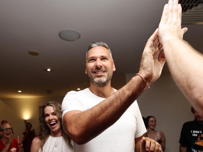 ALP candidate for Leichhardt Matt Smith and his partner Renee Kerr are congratulated by supporters at the post election party, held at the Novotel, as the vote count looks increasingly likely he will win the seat from retiring Member of Parliament Warren Entsch. Picture: Brendan Radke
