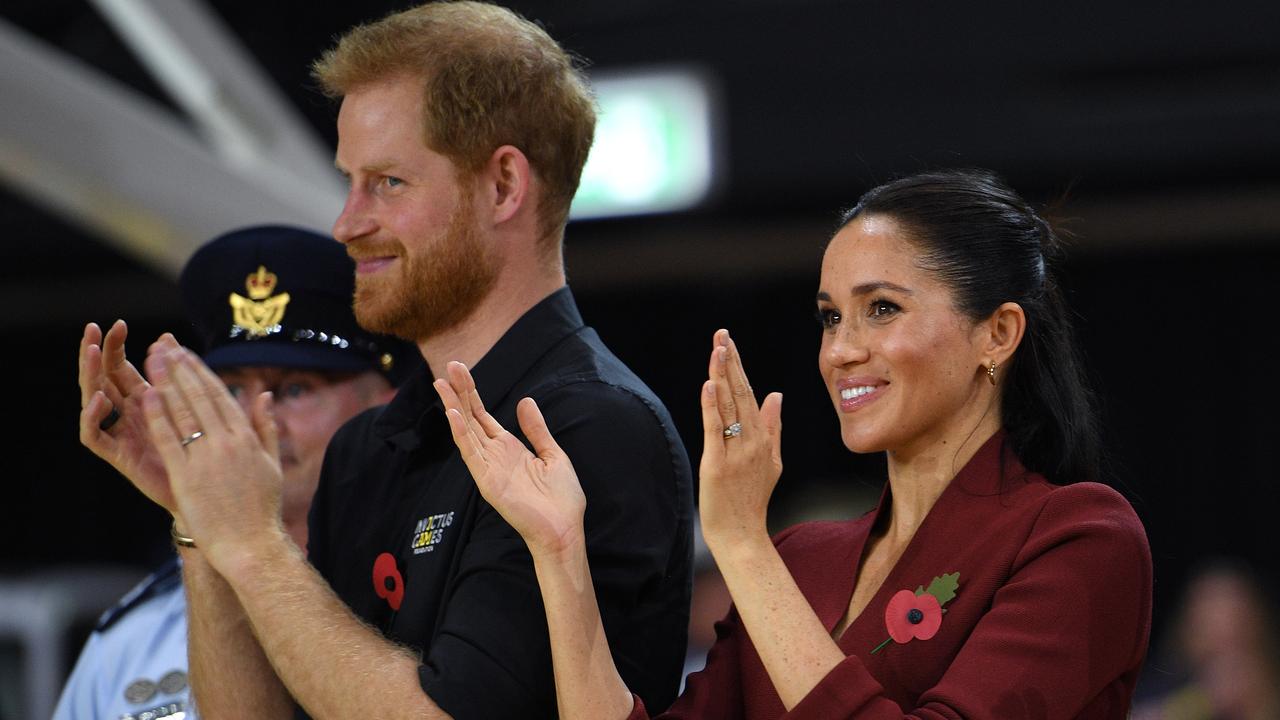 Britain's Prince Harry, the Duke of Sussex and his wife Meghan, the Duchess of Sussex are seen during the medal presentation following the Wheelchair Basketball Final at the Invictus Games in Sydney, Australia, Saturday, October 27, 2018. Picture: AAP Image/Dan Himbrechts