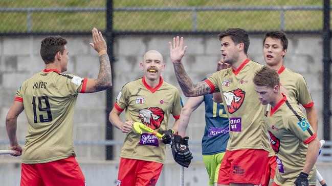 NSW Pride men's team celebrate after scoring against the Tassie Tigers in Hockey One on the weekend.