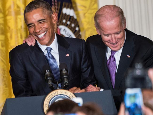 Mr Obama and Mr Biden share a joke. Picture: AFP