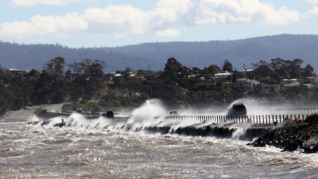 A king tide and high winds create havoc on the Tasman Highway causeway near Midway Point in 2014.