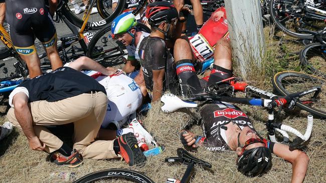 Simon Gerrans (green and blue helmet) sits among the tangled bodies of riders after the crash.