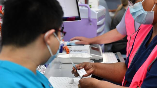 VACCINATION ROLLOUT: A NSW Health worker Andrew Santoso, a Radiographer in the Emergency Department receives his COVID-19 vaccination, Photo: AAP Image/Dean Lewins