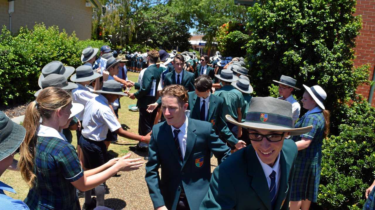 GUARD OF HONOUR: Graduating Year 12 students at St Luke's Anglican School make their way down the traditional guard of honour. Picture: Katie Hall