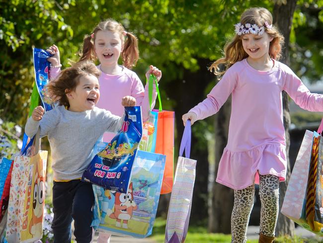 Jasmine (8, flowers in hair), Florence (6) and Andre (2) Foretti with show bags.Picture: Jay Town