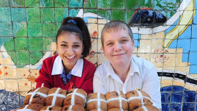 Reservoir High School has hosted a breakfast to raise money for the Feed Melbourne campaign. Students Michael and Latisha with some hot cross buns that were for sale. Picture: Angie Basdekis