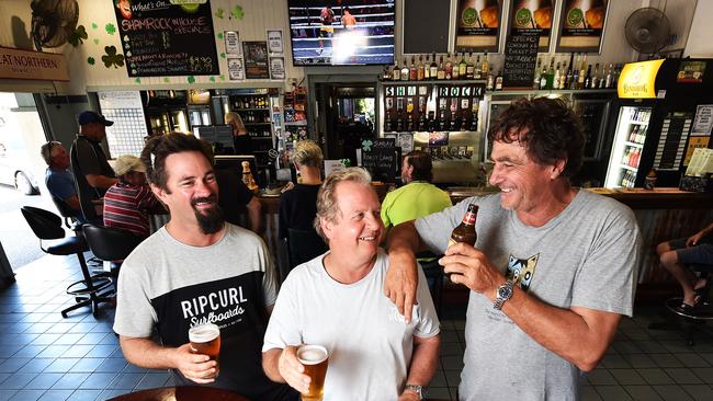 Mates Cheyne Timmermans, Chris Cockcroft and Frank Scharf have a beer at the Shamrock Hotel and talk all things Adani. Picture: Zak Simmonds