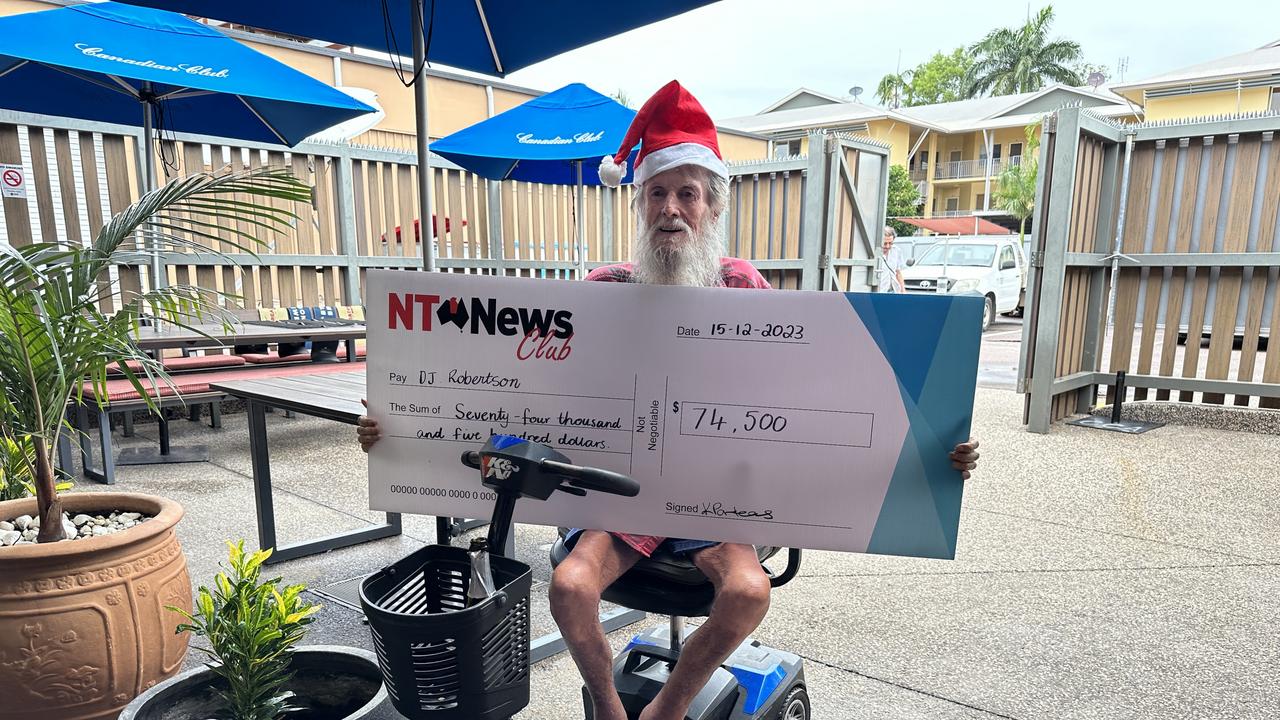 Sunday Territorian bingo winner DJ Robertson with his cheque for $74,500 at Parap Tavern.