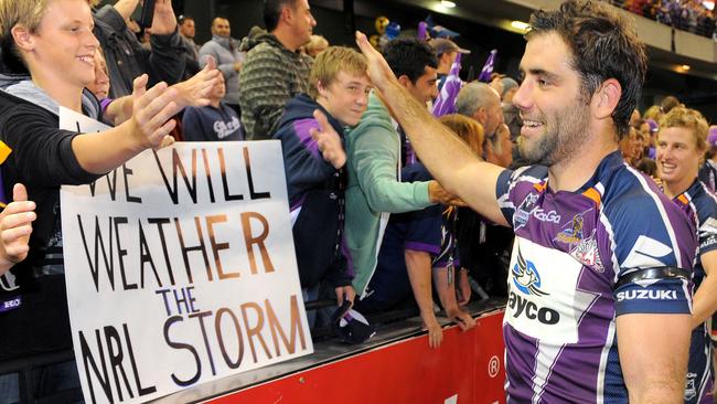 Cameron Smith high-fives fans after the Melbourne Storm defeated the New Zealand Warriors in their first match since been found guilty of breaching the salary cap Picture: AFP