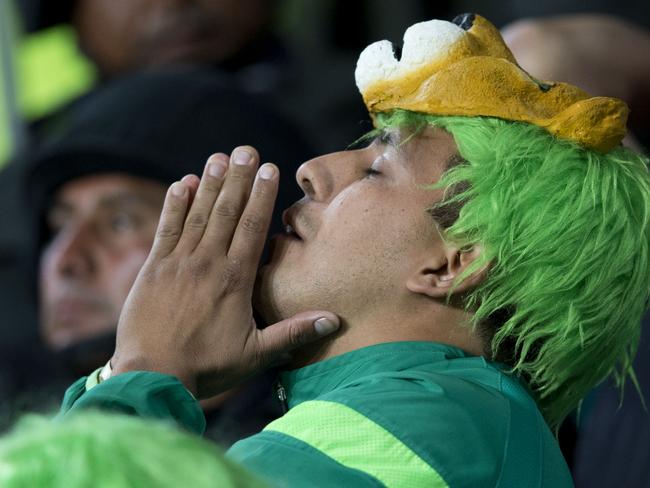 A fan of Mexico’s Leon prays for his team.