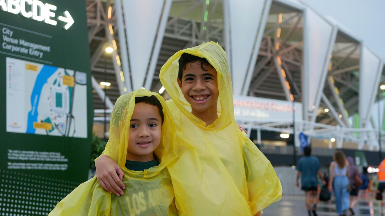 The rain couldnÃ¢â&#130;¬â&#132;¢t wipe the smiles off Zedekiah, 5, Jeffrey, 7 at the NRL All Stars matches in Townsville on Friday. Picture: Blair Jackson