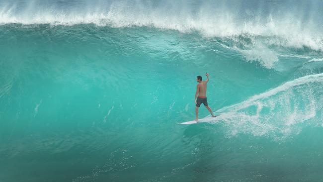 One of the Mad Hueys, Dean Harrington, films the wave he rides. Picture Glenn Hampson