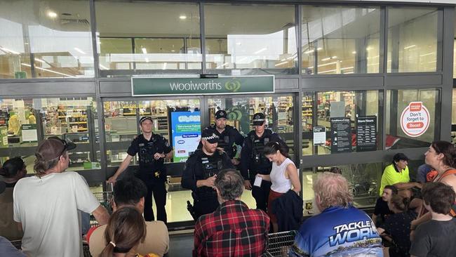 About 200 locals were lined up for food and supplies outside Woolworths in Ingham with police at the door to supervise. Photo Cameron Bates