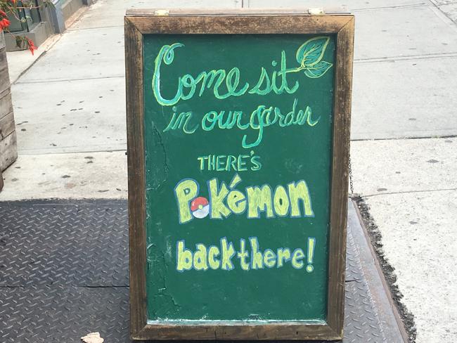 A sandwich board outside a bar in Harlem, Manhattan says you can catch a Pokemon Go creature if you go to their garden ( and have a beer).