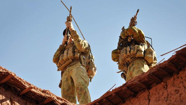 Australian soldiers from the Special Operations Task Group in 2009 using their rifle scopes to investigate the surrounding mountains during an operation in southern Afghanistan. Picture: Stu Dood/Australian Department of Defence/AFP