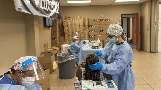 Medical workers from New York wearing personal protective equipments test for COVID-19 at temporary testing site in Houston, Texas.