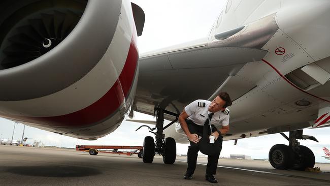 Virgin First Officer Ian Morrison performs a pre flight inspection on his aircraft. Picture: Lyndon Mechielsen