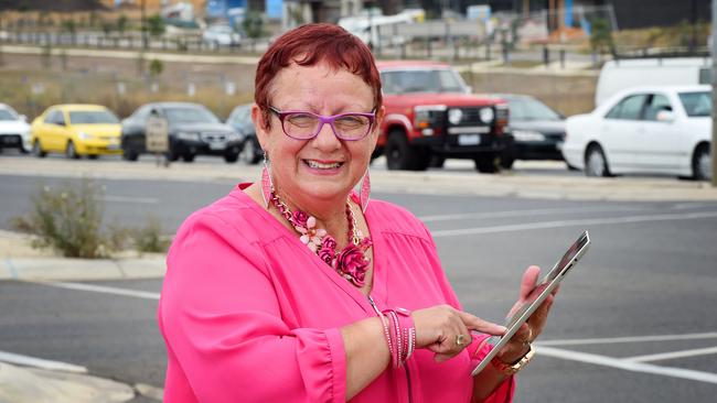 Hume Council is urging people to head online to fill out an RACV survey on congestion. Mayor Helen Patsikatheodorou with traffic filling out the survey with new houses being built in background. Picture: Josie Hayden