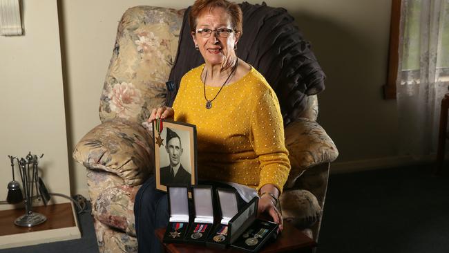 Deirdre English with her father-in-law Lewis William English’s WWII service medals. Picture: George Salpigtidis