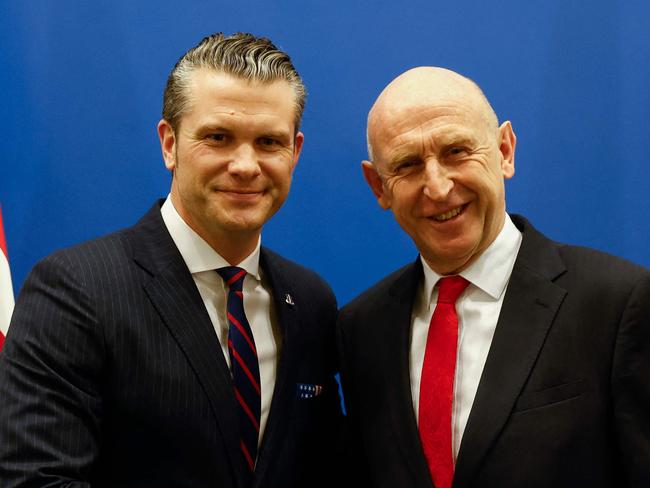 TOPSHOT - US Defense Secretary Pete Hegseth (L) shakes hands with British Defence Secretary John Healey, on the eve of a NATO defence ministers' meeting at the alliance's headquarters in Brussels, on February 12, 2025. New US Secretary of Defense Pete Hegseth arrives for his first meetings at NATO headquarters on February 12 looking to push European nations over support for Ukraine and ramping up military spending. Washington's allies are waiting nervously for clarity from President Donald Trump's administration after the volatile leader demanded NATO more than double its spending target and vowed to end the war in Ukraine. (Photo by Johanna Geron / POOL / AFP)