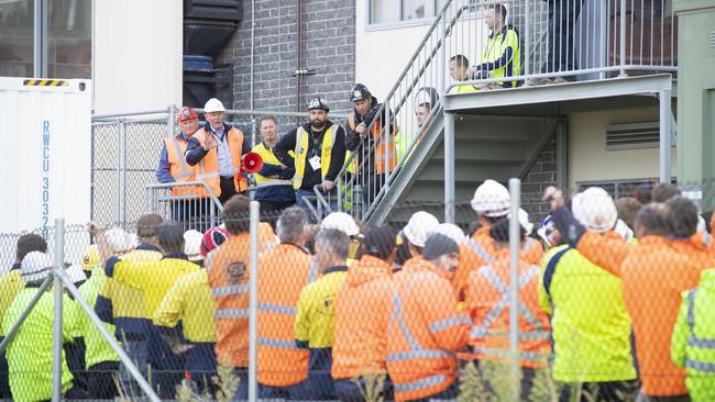 Staff meeting with builder John Holland on site after a potential asbestos exposure at the construction site. Picture: RICHARD JUPE