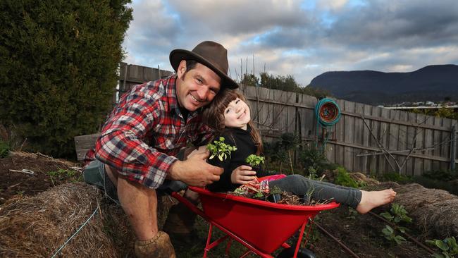 Tino Carnevale with daughter Eden in their vegetable garden at home in Hobart. Picture: NIKKI DAVIS-JONES