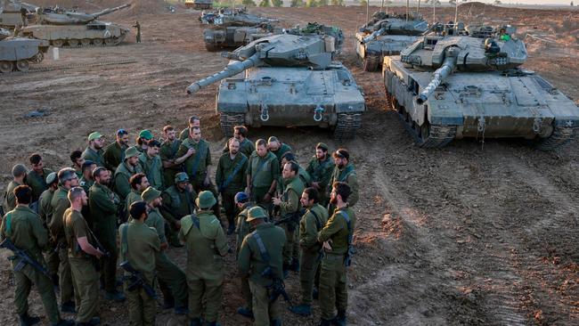 Israeli soldiers deployed on the southern border with the Gaza Strip gather for a briefing. Picture: AFP.