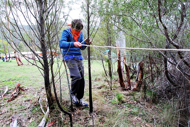 <p>James Winter, 12, from the Cressy Scouts, following the rope through the bush blindfolded. Picture: Kim Eiszele</p>