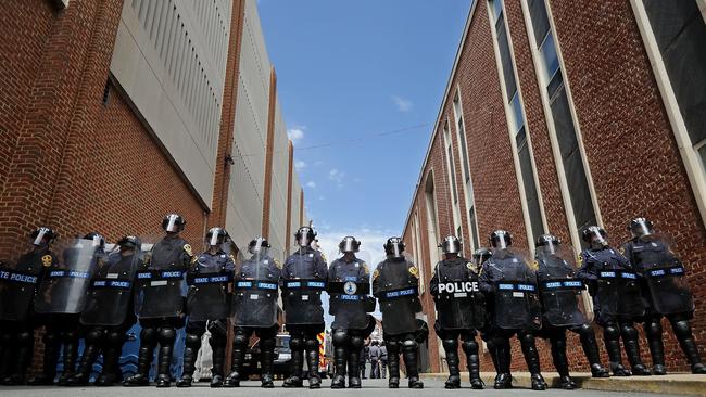 Virginia State Police wear body armour and use riot shields while forming a cordon around police headquarters. Picture: AFP