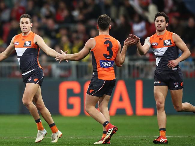 SYDNEY, AUSTRALIA - JULY 14:  Josh Kelly of the Giants (L) celebrates with team mates after kicking a goal during the round 17 AFL match between the Greater Western Sydney Giants and the Richmond Tigers at Spotless Stadium on July 14, 2018 in Sydney, Australia.  (Photo by Matt King/Getty Images)