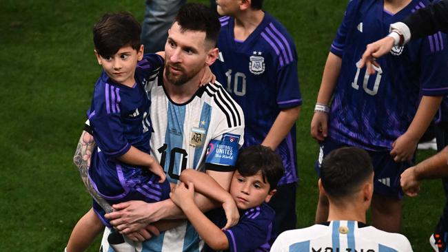 Argentina's forward #10 Lionel Messi hugs his children.