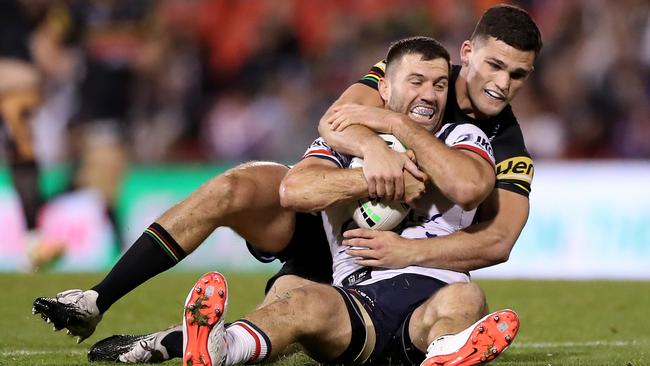 Roosters fullback James Tedesco is tackled by Nathan Cleary. Picture: Getty Images