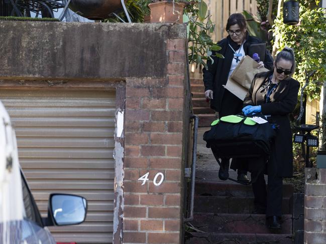 Police take evidence bags from the house on Friday. Picture: Tom Parrish