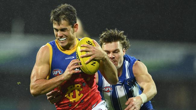 The Lions’ Deven Robertson tries to slip away from the tackle of Cameron Zurhaar during their at Blundstone Arena on Saturday. Picture: Getty