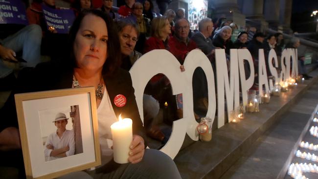 Liz, and Bret Habermann, with a photograph of her son Rhys, who took his own life to due illness at the euthanasia vote vigil on the steps of Parliament House last month. Picture: Kelly Barnes