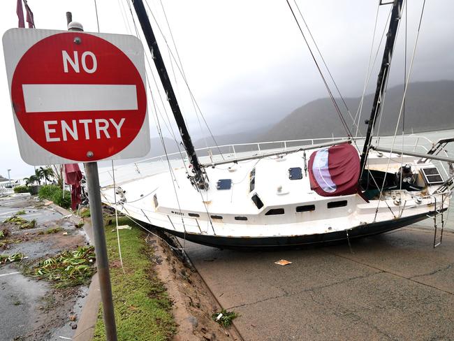 A boat is seen smashed against the bank at Shute Harbour, Airlie Beach after the cyclone hit yesterday. Picture: AAP Image/Dan Peled