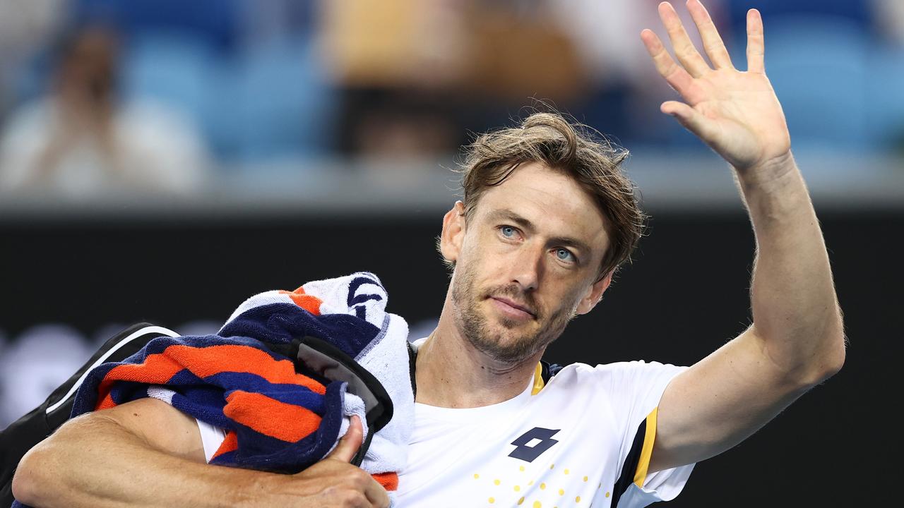 John Millman waves to fans after his win, where a fight is believed to have broken out in the stands. Picture: Getty Images