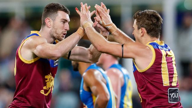 Daniel McStay and Jarryd Lyons celebrate a goal as the Brisbane Lions overcame a determined Gold Coast Suns at the Gabba. Picture: Russell Freeman/AFL Photos via Getty Images