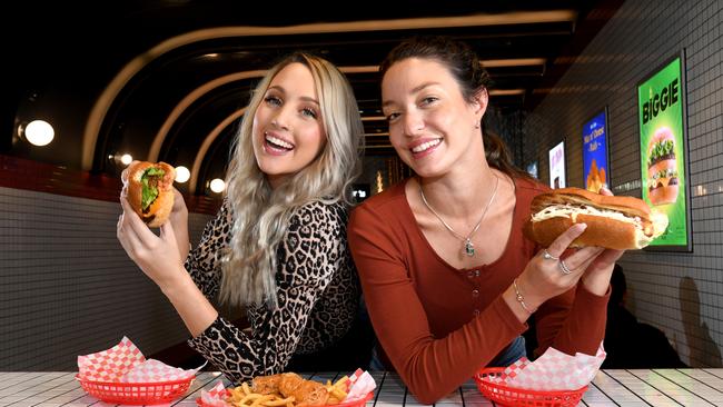 Vegan Dimity Tubb, 27, and vegetarian Georgia Cornell, 26, enjoy a Beyond Meat burger, a soya based hot dog and ‘Phish’ and chips from Lord of the Fries on Hindley Street. Picture: Tricia Watkinson