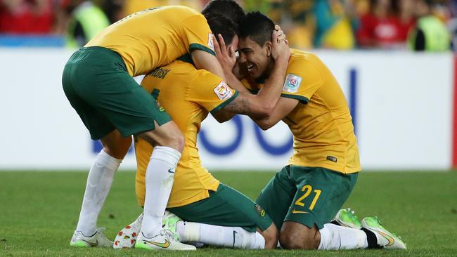 The Socceroos celebrate Massimo Luonog’s stunning opening goal.